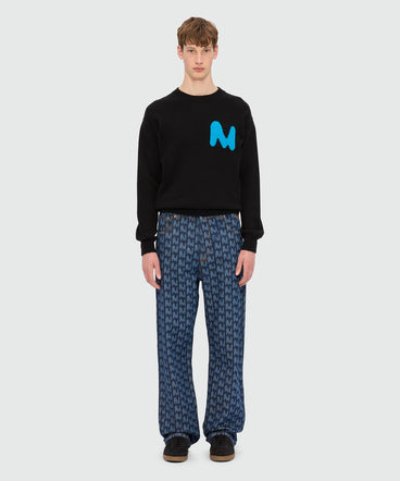 Blue laser-cut denim trousers with "TheMwave" motif