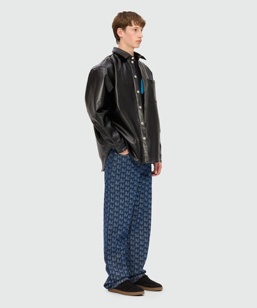 Blue laser-cut denim trousers with "TheMwave" motif