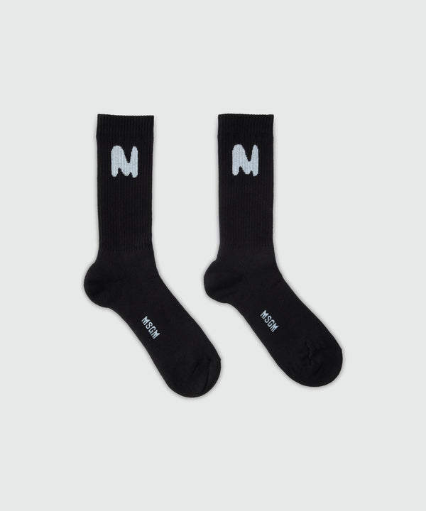 Black socks with "TheMwave" jacquard graphics