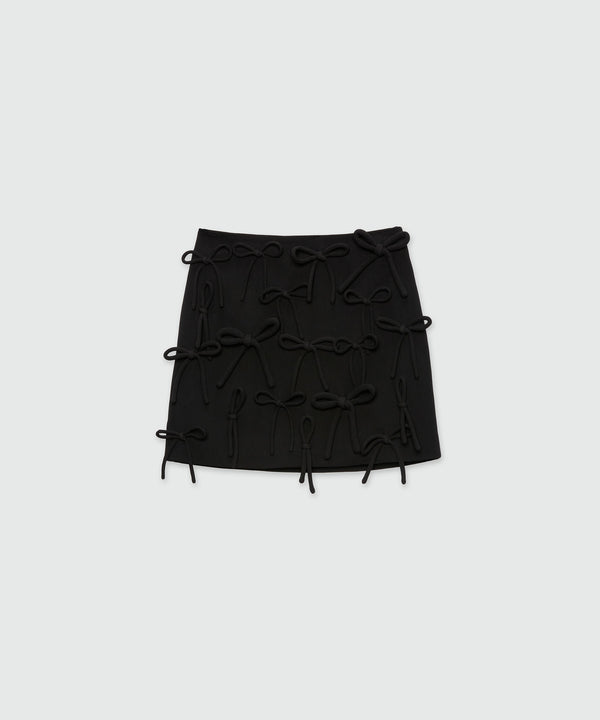 Black miniskirt in double crepe cady with bow detail