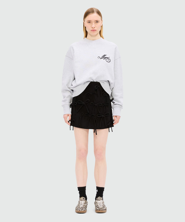 Black miniskirt in double crepe cady with bow detail