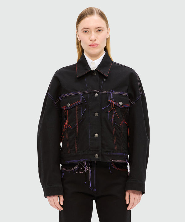 Black denim jacket with multi-colored stitching and threads