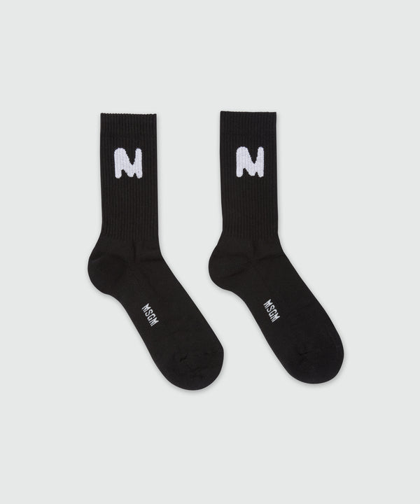 Black socks with "TheMwave" jacquard graphics
