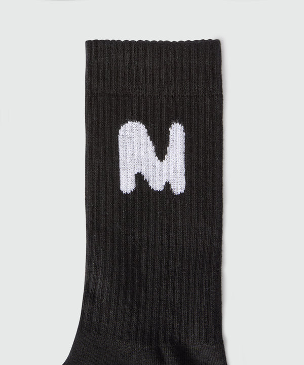 Black socks with "TheMwave" jacquard graphics