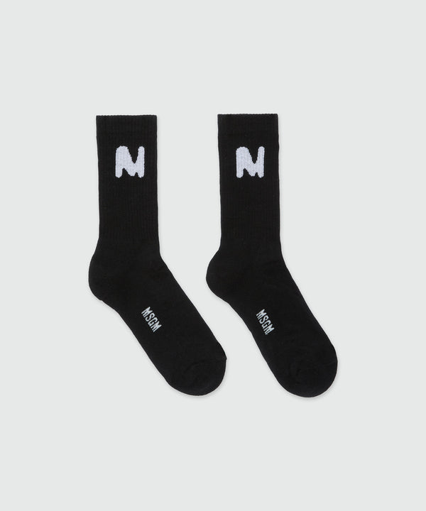 Black socks with "TheMwave" jacquard graphics