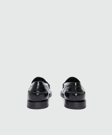 Black leather loafers with "TheMwave" applique