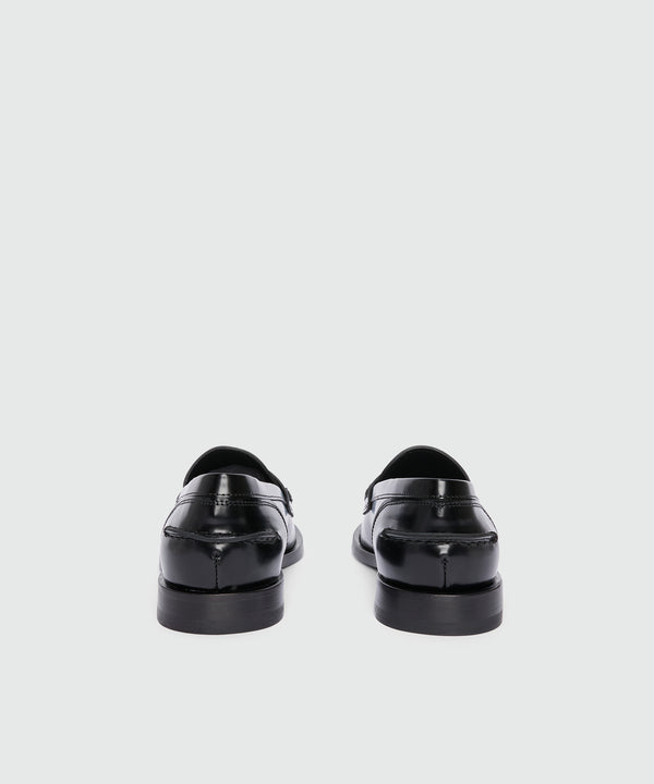 Black leather loafers with "TheMwave" applique