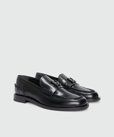 Black leather loafers with "TheMwave" applique