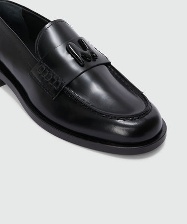 Black leather loafers with "TheMwave" applique