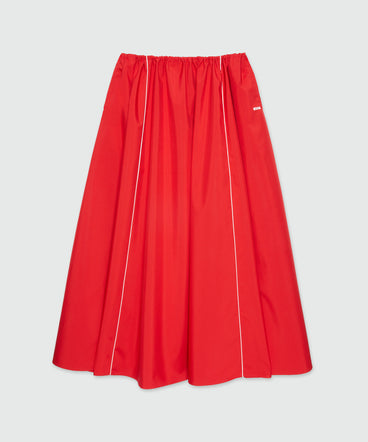 Long red nylon skirt with contrasting piping