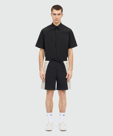 Black stretch cotton Bermuda shorts with color-block inserts.