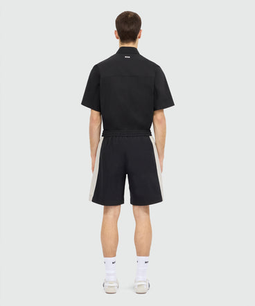 Black stretch cotton Bermuda shorts with color-block inserts.