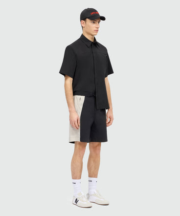 Black stretch cotton Bermuda shorts with color-block inserts.