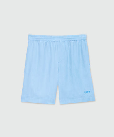Light blue lyocell Bermuda shorts with tie-dye effect treatment and embroidered logo at the hem.