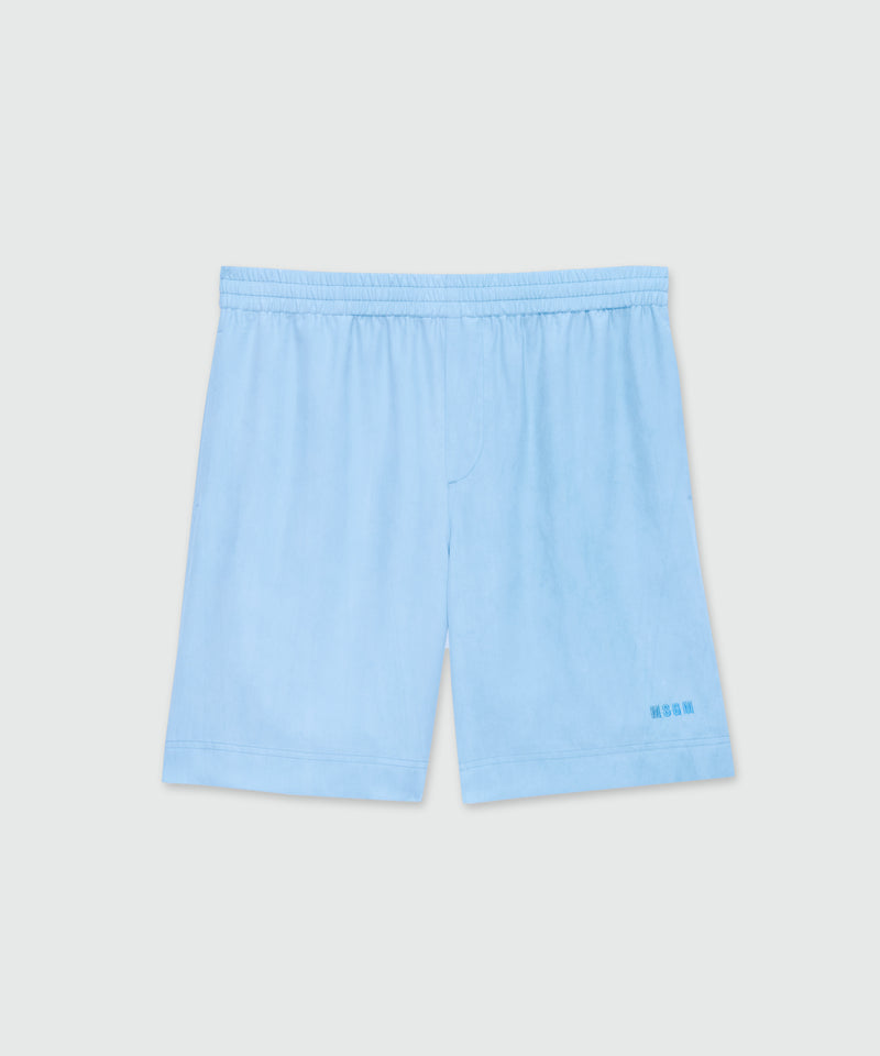 Light blue lyocell Bermuda shorts with tie-dye effect treatment and embroidered logo at the hem. 84 Uomo 