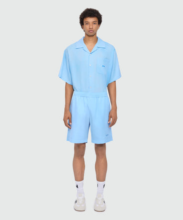 Light blue lyocell Bermuda shorts with tie-dye effect treatment and embroidered logo at the hem.