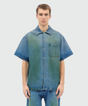 Light-wash denim short-sleeve shirt with localized distressing