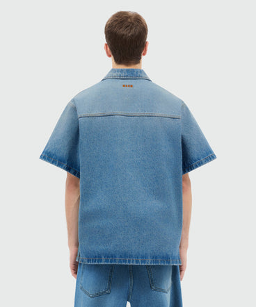 Light-wash denim short-sleeve shirt with localized distressing