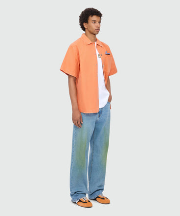 White long-sleeve cotton jersey T-shirt with patch on the chest.