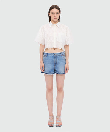 Light blue stone-washed denim shorts with lace detail at the waist