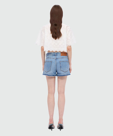 Light blue stone-washed denim shorts with lace detail at the waist