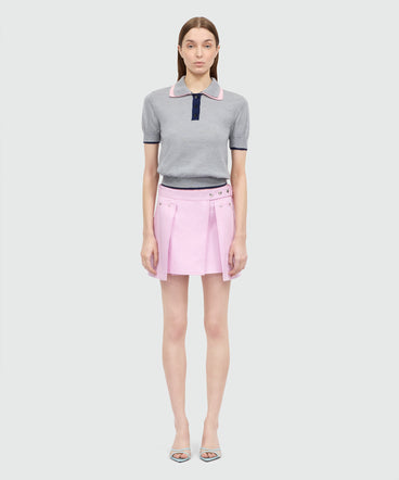 Pink cotton gabardine wrap miniskirt with metal buttons