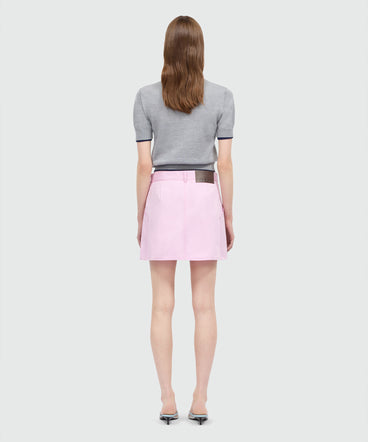 Pink cotton gabardine wrap miniskirt with metal buttons