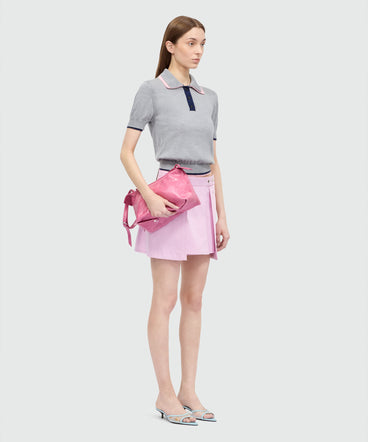 Pink cotton gabardine wrap miniskirt with metal buttons