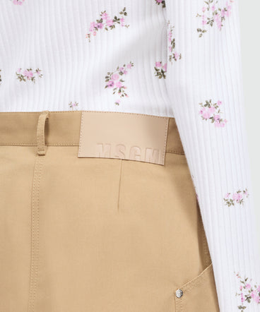 Pink cotton gabardine wrap miniskirt with metal buttons