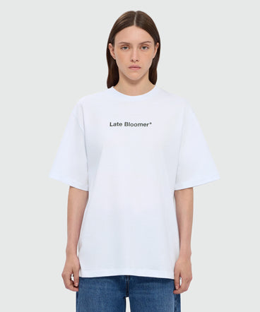 White short-sleeve cotton jersey T-shirt with "Late Bloomer" quote print on the front