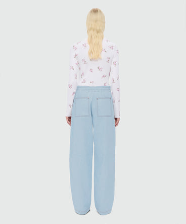 Oversized raw denim trousers with contrast stitching and metal rivets