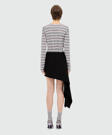 Black cotton poplin mini skirt with asymmetrical detail.