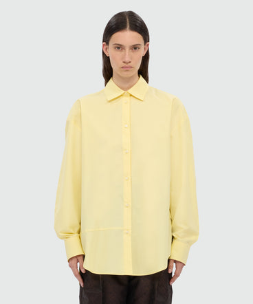 Yellow cotton poplin shirt with asymmetrical detail.