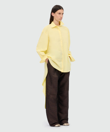 Yellow cotton poplin shirt with asymmetrical detail.