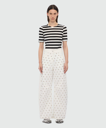 White barrel-fit trousers with studs.