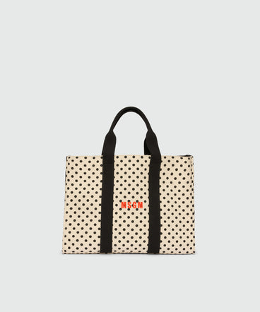 Horizontal canvas tote with polka dot print.