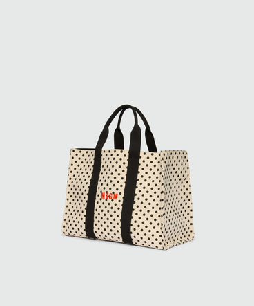 Horizontal canvas tote with polka dot print.