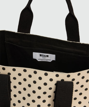 Horizontal canvas tote with polka dot print.